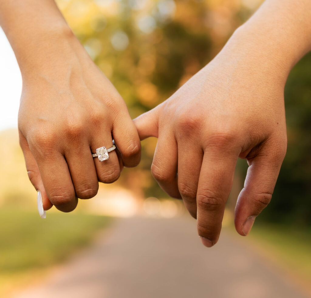 Close up of a couple holding pinky fingers and showing an engagement ring during their Illinois elopement.