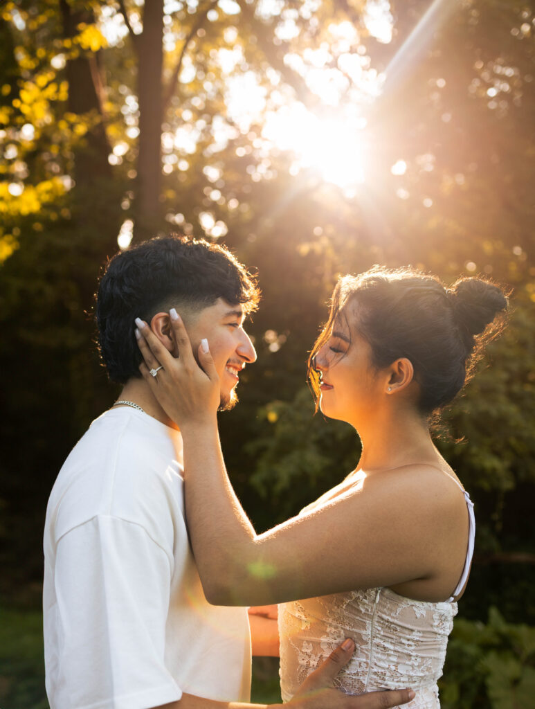 Couple sharing an intimate moment in golden sunlight during their Illinois forest elopement.