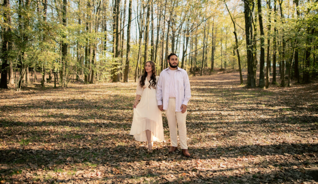 Couple walking through a sunlit forest during their Illinois elopement.