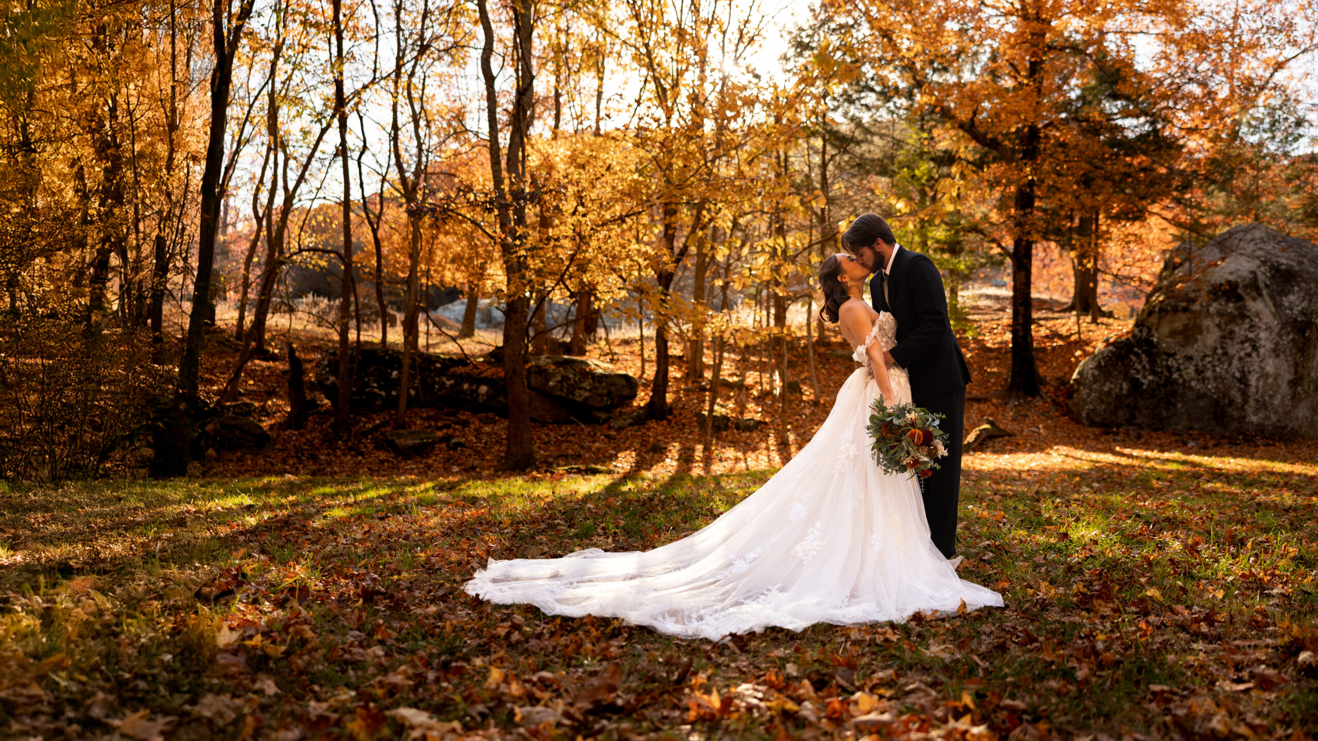 Bride and groom standing together during a fall elopement in an Illinois forest surrounded by autumn foliage