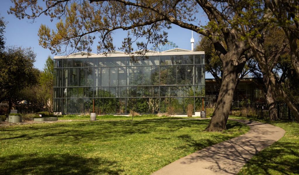 Glass conservatory and garden path at Texas Discovery Gardens in Dallas, Texas